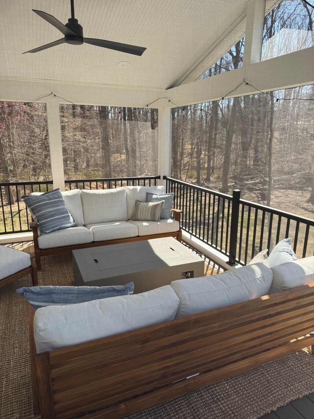 screened in porch with patio furniture and a fireplace